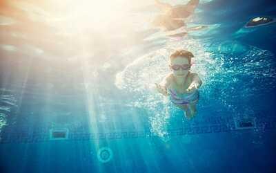 a boy swimming in clean swimming pool